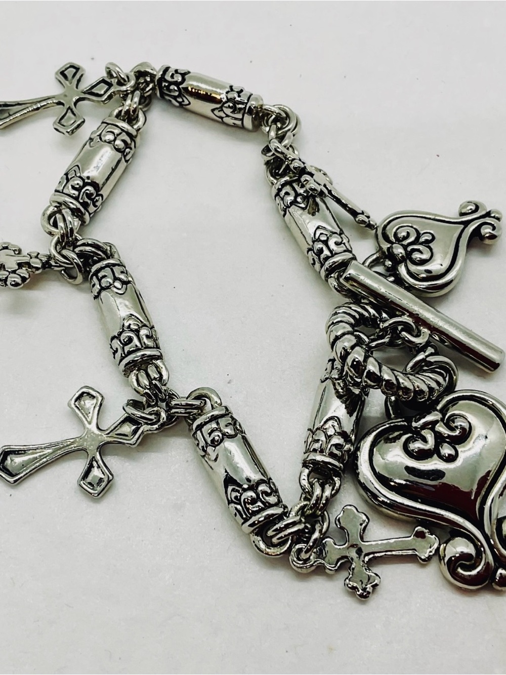 Silver Toned Charm Bracelet With Various Styles Of Hearts&Crosses Toggle Clasp